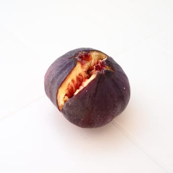 Fig or fig tree, or common fig tree, or Ficus carica is a subtropical deciduous plant of the genus Ficus of the Mulberry family. Ripe purple fig fruits on a light background. Healthy food.