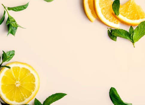 Citrus slices and mint herbs frame on retro pastel  background with copyspace