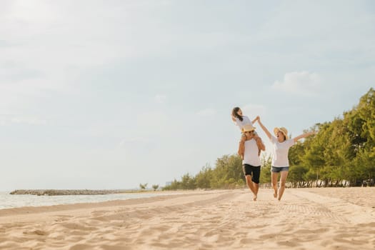 Family day. Happy family people having fun in summer vacation run on beach, daughter riding on father back and mother running at sand beach, family trip playing together outdoor, traveling in holiday