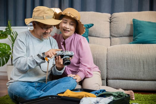 Travel and tourism. Happy mature retired couple photography weekend holiday, Asian couple old senior marry retired couple smiling taking photo by camera during luggage suitcase arranging for travel