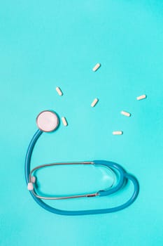 Medicine debate concept. Biotechnology banner with medical stethoscope and pills. Copy space for text. flatlay.