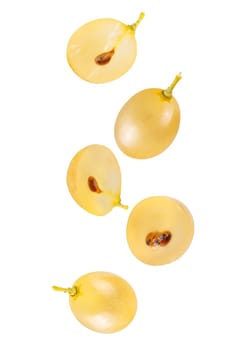 Isolated flying grapes. Five whole and sliced grape fruits falling on white with clipping path as package design element and advertising. Full depth of field.