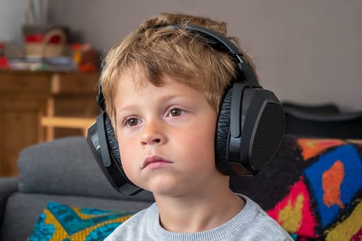 a little boy with headphones at home