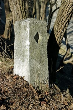 Old stone sign by the road.