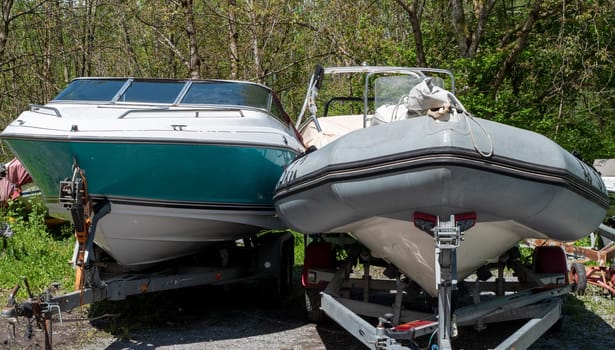 Two motor boats on the trailers at parking