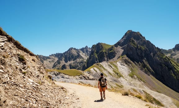 hiker walking at a path of Pic du Midi de Bigorre in french Pyrenees mountains