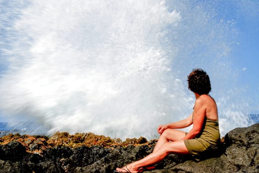 a woman near Le Souffleur geyser at Reunion Island close to Saint Leu city