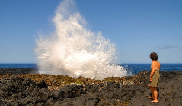 a woman near Le Souffleur geyser at Reunion Island close to Saint Leu city