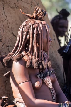 May 15, 2005. portrait of unidentified Himba woman  with the traditional hairstyle, necklace and the typical ochre tinted skin. Epupa Falls, Kaokoland or Kunene Province, Namibia, Africa