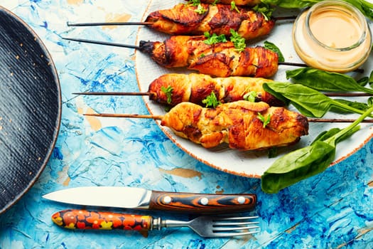 Tasty chicken meat with peanut sauce, chicken fillet roasted on wooden stick. Kebabs