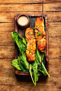 Tasty chicken meat with peanut sauce, chicken fillet roasted on wooden stick. Kebabs