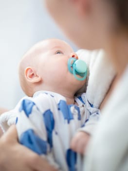 Young mother is holding her little baby