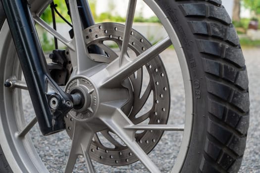 a close-up of motorcycle brakes and front wheel