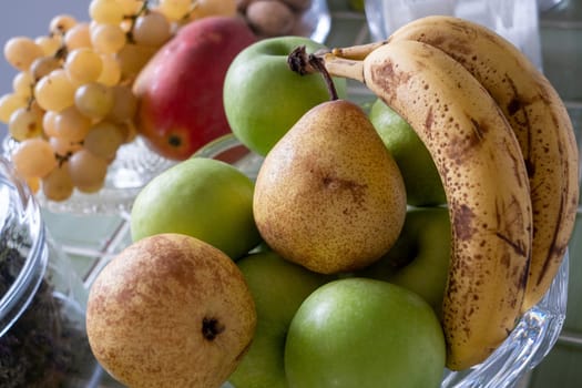 a glass bowl of fruits