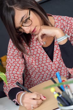 a young business entrepreneur woman working with eyeglasses at home