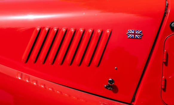 a detail of the bonnet of a red car