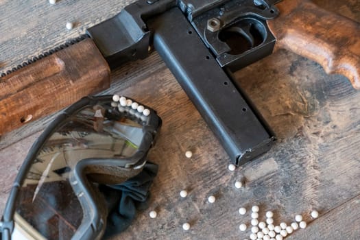 airsoft gun with protective glasses and a lot of bullets
