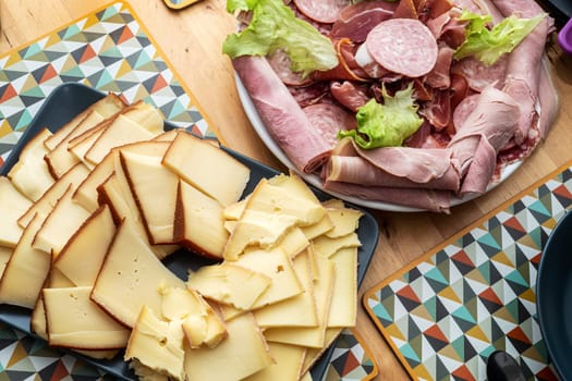 Raclette cheese and meat, a french tradition