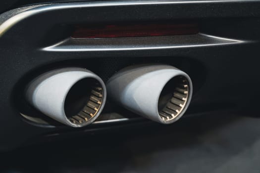 detail rear view of black sport car pair of exhaust pipes