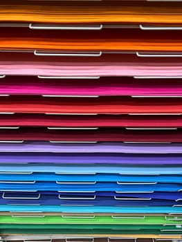 closeup front view of many various art colored paper cardboard canvas samples on display shelf