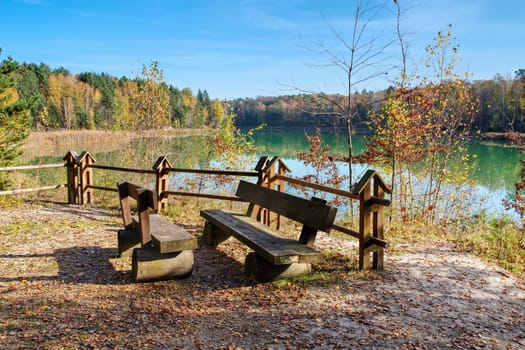 Autumn forest by the lake, indian summer with seating group