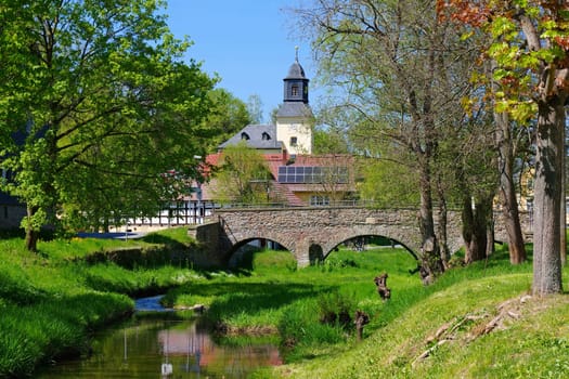 the village of Rohma in Vogtland with church and bridge in spring, Germany