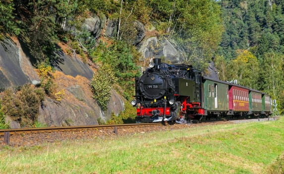 old steam locomotive in rocky mountains landscape