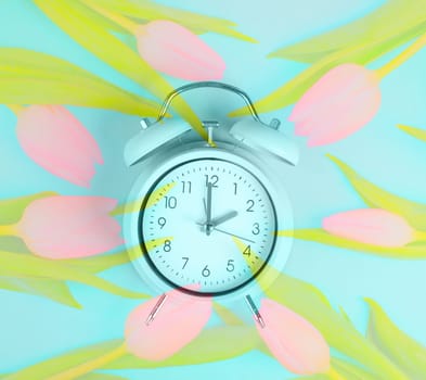 Alarm clock with tulips, switch to daylight saving time in spring, summer time changeover
