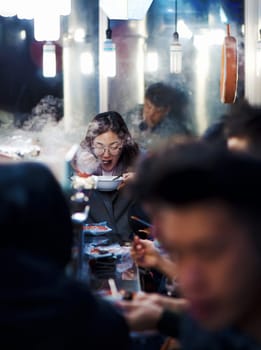 seoul, south korea - 11th november 2017: foodies pack the crowded traditional food street stalls at gwangjang market