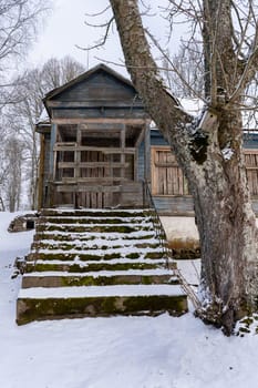 Old barn in the village on a winter day