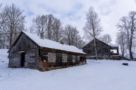 Old barn in the village on a winter day