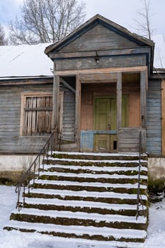 Old barn in the village on a winter day