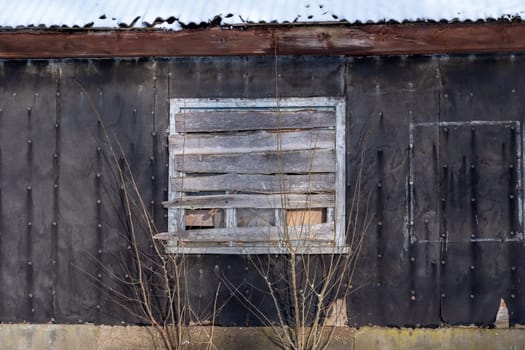 Old barn in the village on a winter day