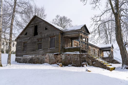 Old barn in the village on a winter day