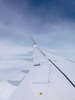 Air Plane wing on the blue sky and clouds