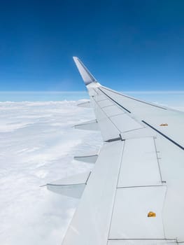 Air Plane wing on the blue sky and clouds