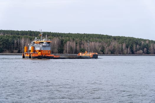 KLAIPĖDA, LITHUANIA - April, 2021 Orange barge in the Baltic Sea