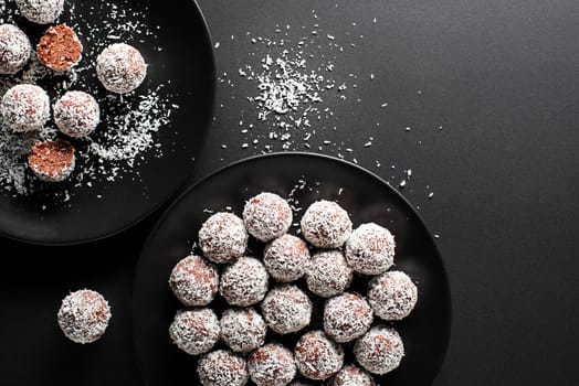 Delicious Coconut-Chocolate balls covered with grated coconut. Soft, delicious and fudgy coconut balls with rum, biscuit and chocolate.