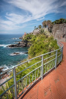 View of the beautiful promenade of Nervi in Genoa, with palm trees and bricks, Italy.