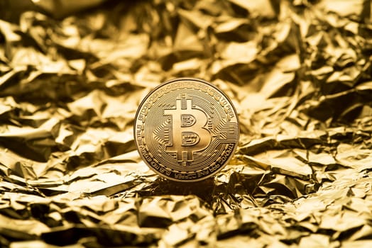Golden coin with bitcoin symbol close up. Bitcoin and cryptocurrency investing concept. Bitcoin cryptocurrency coin. Trading on the cryptocurrency exchange. Trends in bitcoin exchange rates.