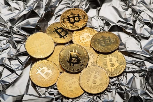 Golden coins with bitcoin symbol close up. Bitcoin and cryptocurrency investing concept. Bitcoin cryptocurrency coins. Trading on the cryptocurrency exchange. Trends in bitcoin exchange rates.