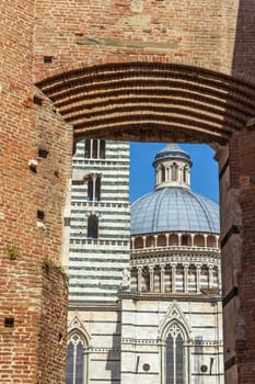 Viista of Dome and Campanile of Siena Cathedral. Old Town of medieval city of Siena. Tuscany. Italy.