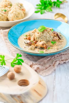 Homemade Bavarian bread dumpling, called in south Germany as Semmelknoedel with creamed mushroom sauce