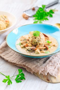 Homemade Bavarian bread dumpling, called in south Germany as Semmelknoedel with creamed mushroom sauce
