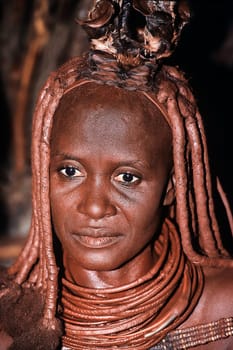 May 15, 2005. portrait of unidentified Himba woman  with the traditional hairstyle, necklace and the typical ochre tinted skin. Epupa Falls, Kaokoland or Kunene Province, Namibia, Africa.