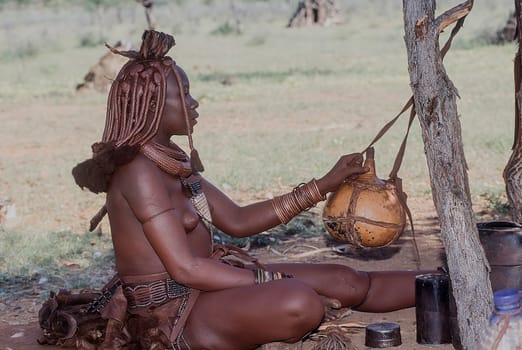 May 15, 2005. portrait of unidentified Himba woman with the traditional hairstyle, necklace and the typical ochre tinted skin. Epupa Falls, Kaokoland or Kunene Province, Namibia, Africa