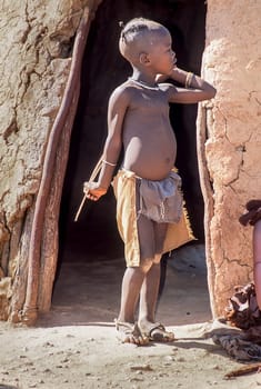 May 15, 2005. unidentified himba boy in the traditional hut, Epupa Falls, Kaokoland or Kunene Province, Namibia, Africa