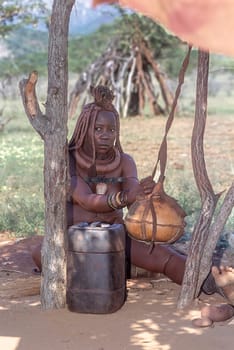 May 15, 2005. portrait of unidentified Himba woman with the traditional hairstyle, necklace and the typical ochre tinted skin. Epupa Falls, Kaokoland or Kunene Province, Namibia, Africa