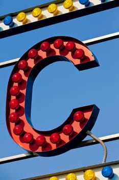 classic electric sign like the ones used in circus or old fashioned shops representing the C letter