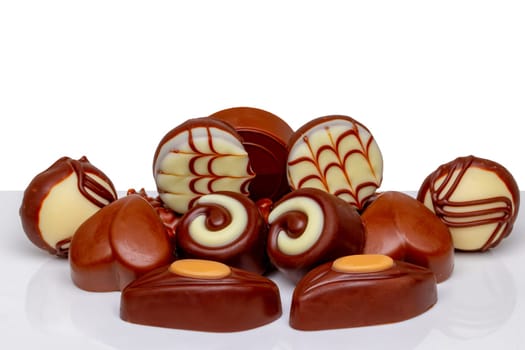 Chocolate candies collection. Beautifully assortment of various swizz chocolate candies sweets on table isolated of a white background.